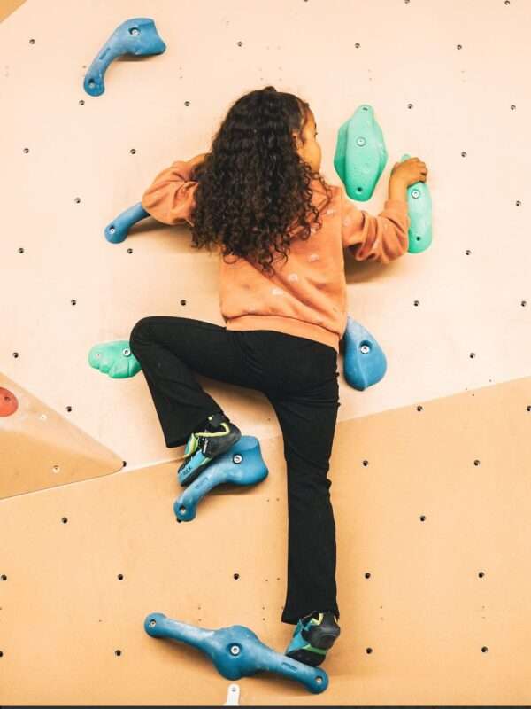 Girl climbing at Indirock bouldering wall